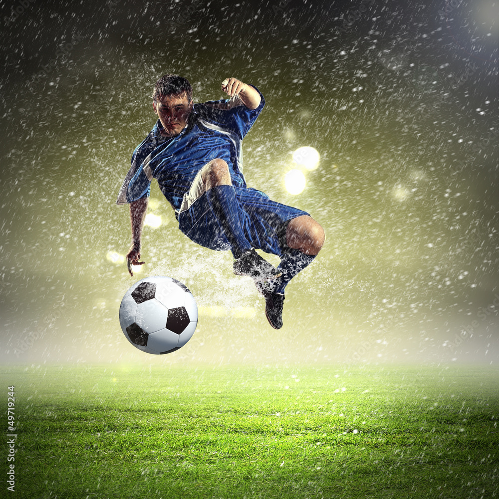 Naklejka premium football player striking the ball