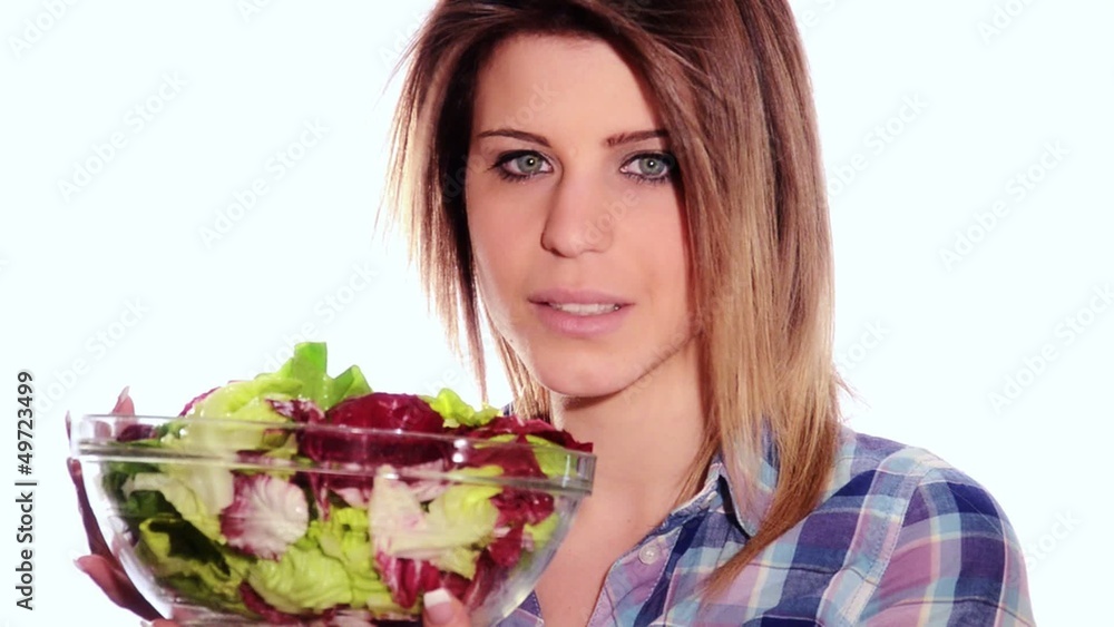healthy young woman eating lettuce