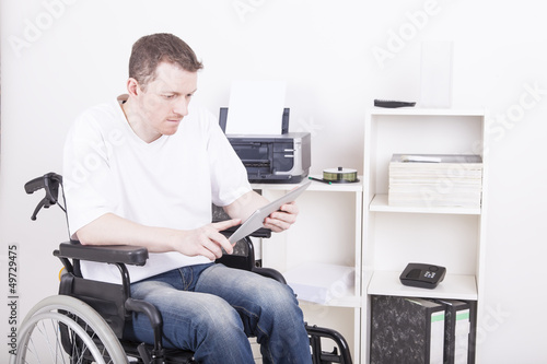 young man in wheelchair using a tablet pc © D. Ott