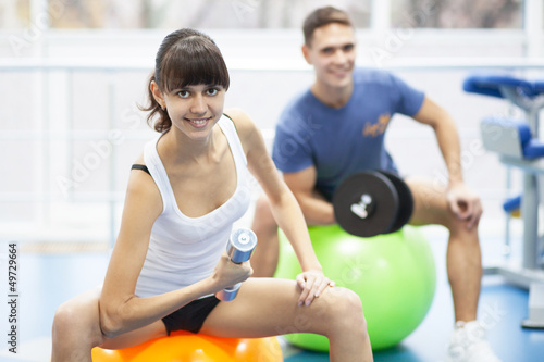 Cheerful young couple in a gym