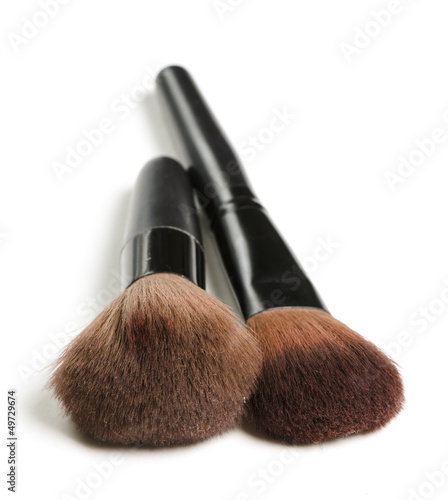 Brushes in a row. The photo shows many makeup brushes.