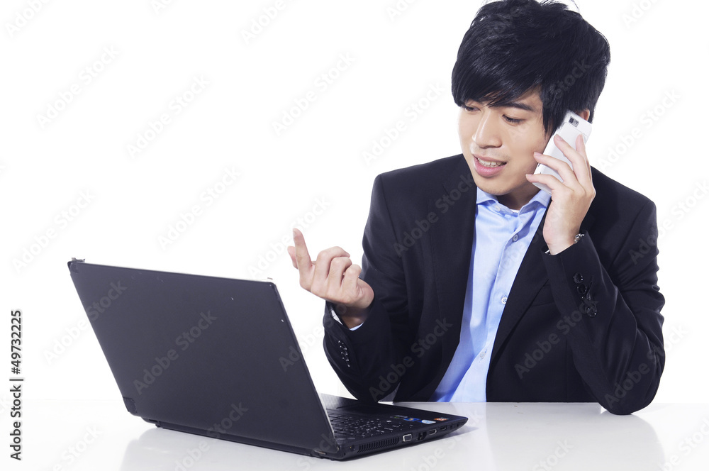 business man speaking on cellphone and working on laptop business man speaking on cellphone and working on laptop