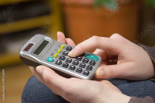 woman's hands with a calculator