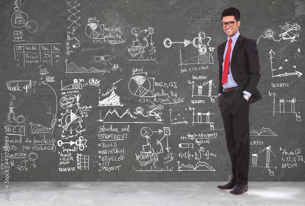 business man stands in front of blackboard business man stands in front of blackboard