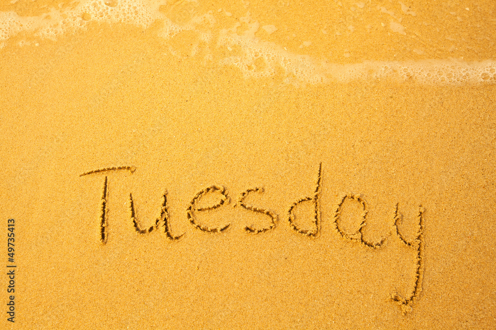 Fototapeta premium Tuesday - written in sand on beach texture(days week series)