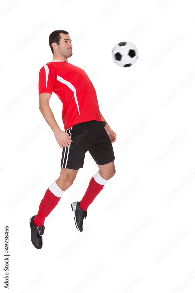 Professional soccer player kicking ball