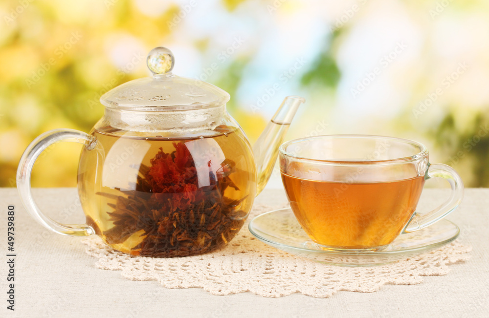 Exotic green tea with flowers in glass teapot Exotic green tea with flowers in glass teapot