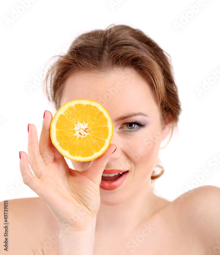 Beautiful young woman with bright make-up, holding orange,