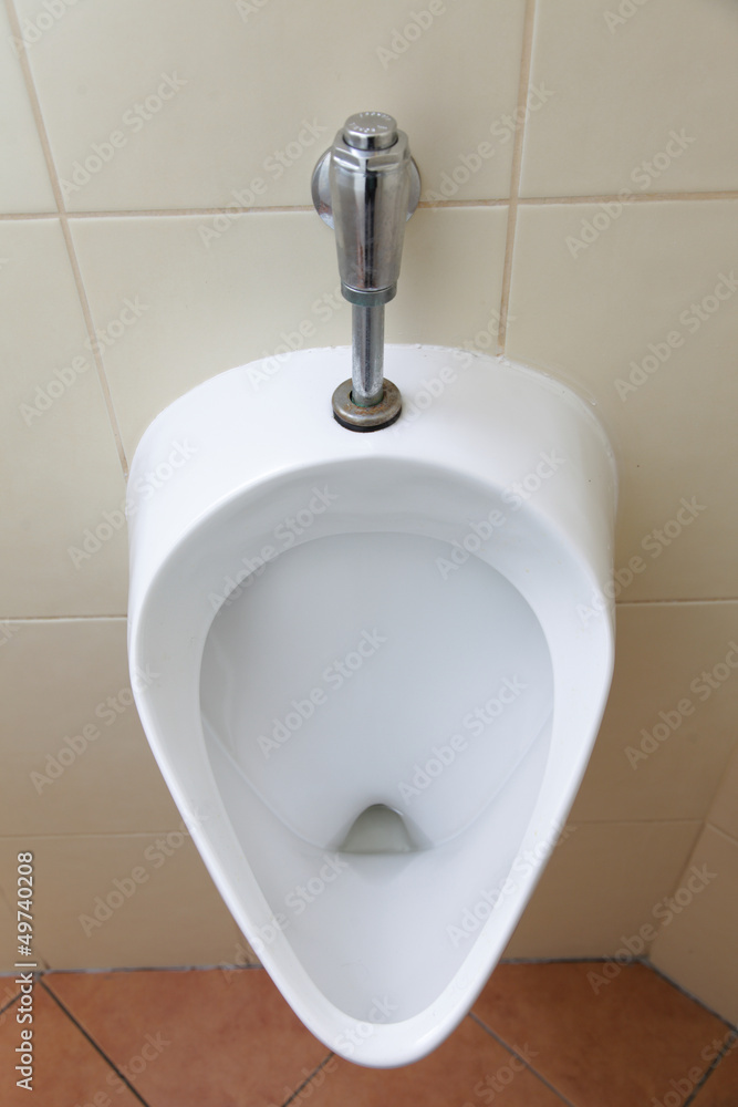 Fototapeta premium White porcelain urinal in public toilets