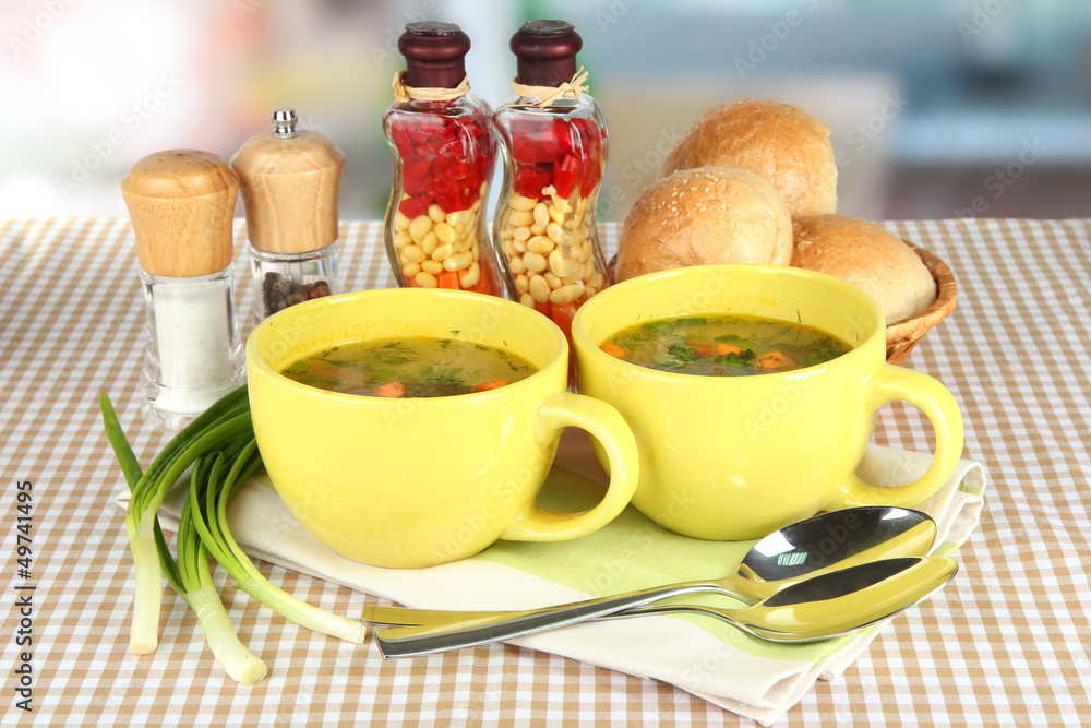 Fragrant soup in cups on table in kitchen Fragrant soup in cups on table in kitchen