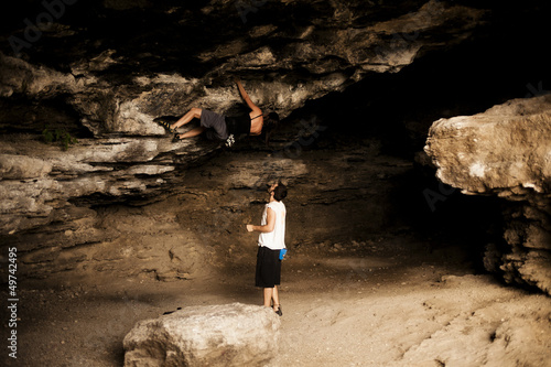 Young woman taking climbing lessons photo