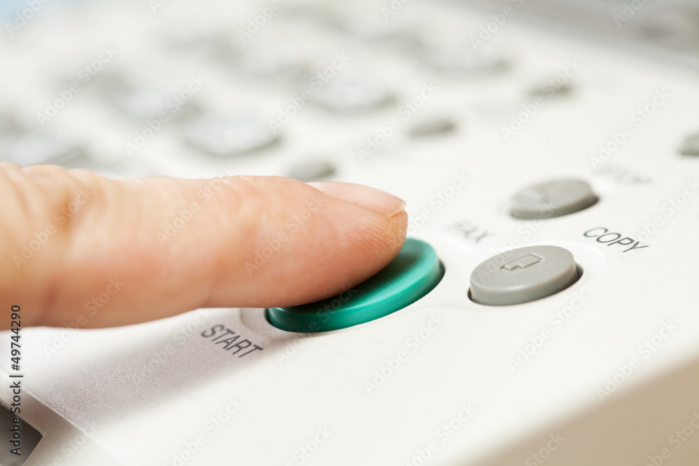 Office life, hand pressing start button on fax, copy machine Office life, hand pressing start button on fax, copy machine