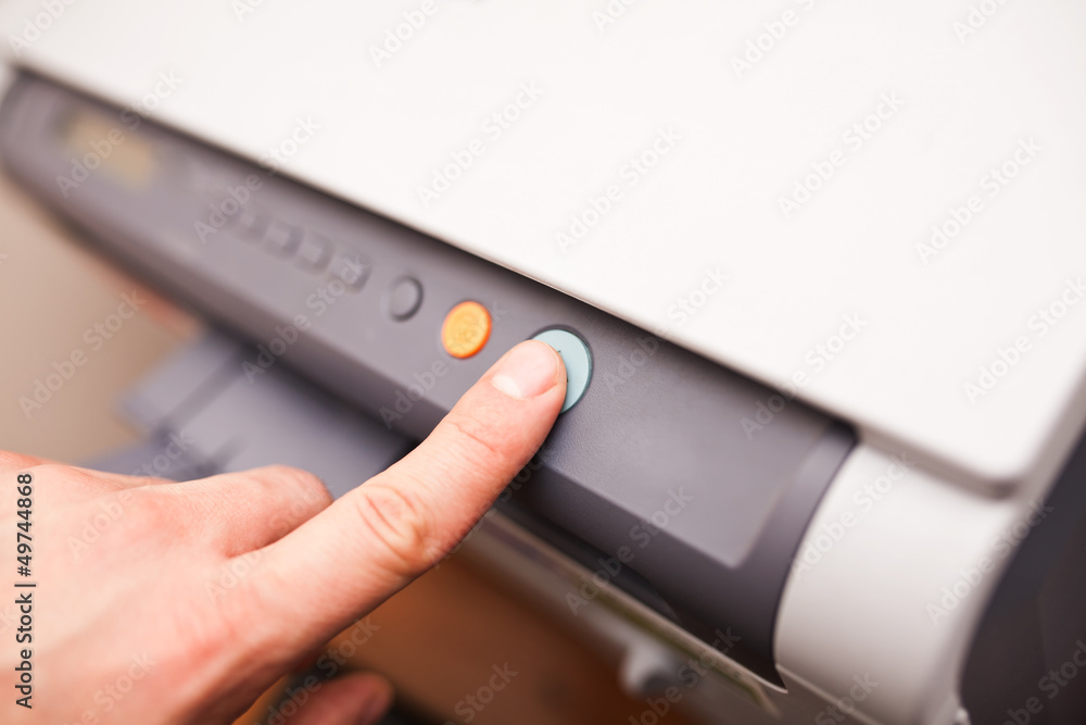 Office life, hand pressing start button on fax, copy machine Office life, hand pressing start button on fax, copy machine