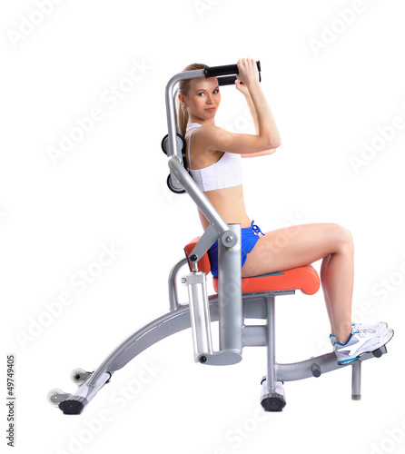 Lovely woman training on hydraulic exerciser