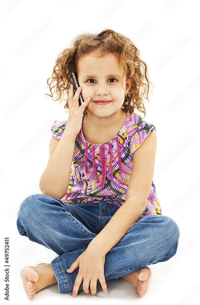 Cute little girl is talking on cell phone Cute little girl is talking on cell phone