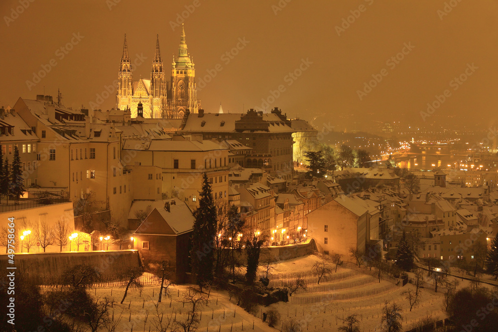 Night snowy Prague City with gothic Castle, Czech republic