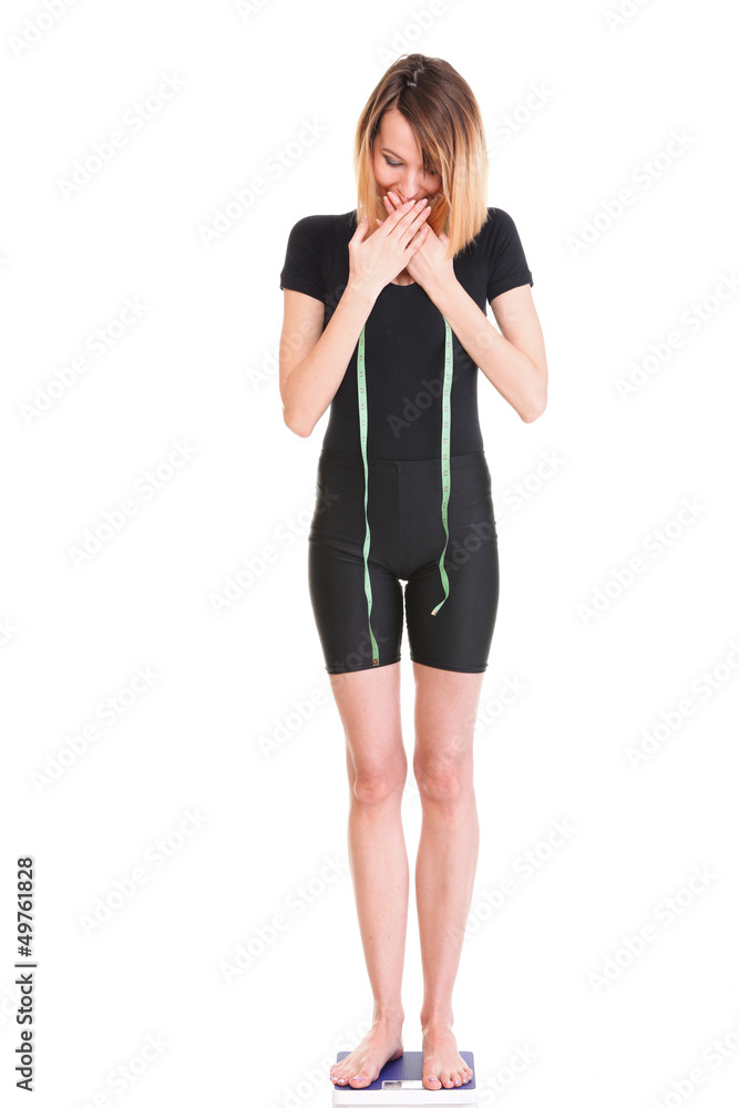 Fototapeta premium Caucasian young woman weight scale looking camera isolated white