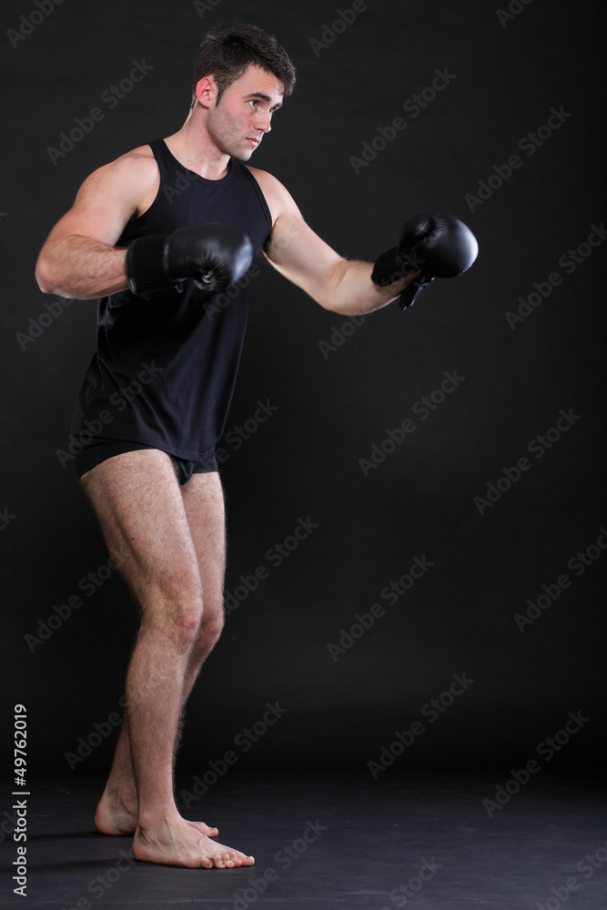 Portrait sportsman boxer in studio dark background Portrait sportsman boxer in studio dark background