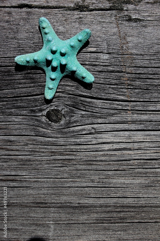 Blue starfish on a barnboard background announcement Blue starfish on a barnboard background announcement