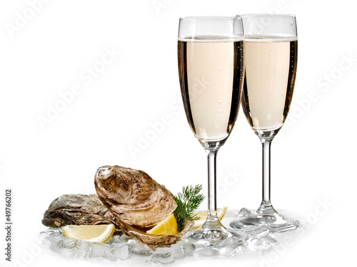 Two champagne glasses with two oysters