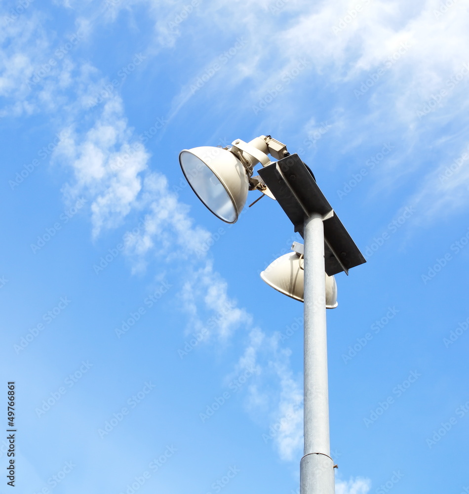 Tall modern floodlights against a bright blue sky Tall modern floodlights against a bright blue sky