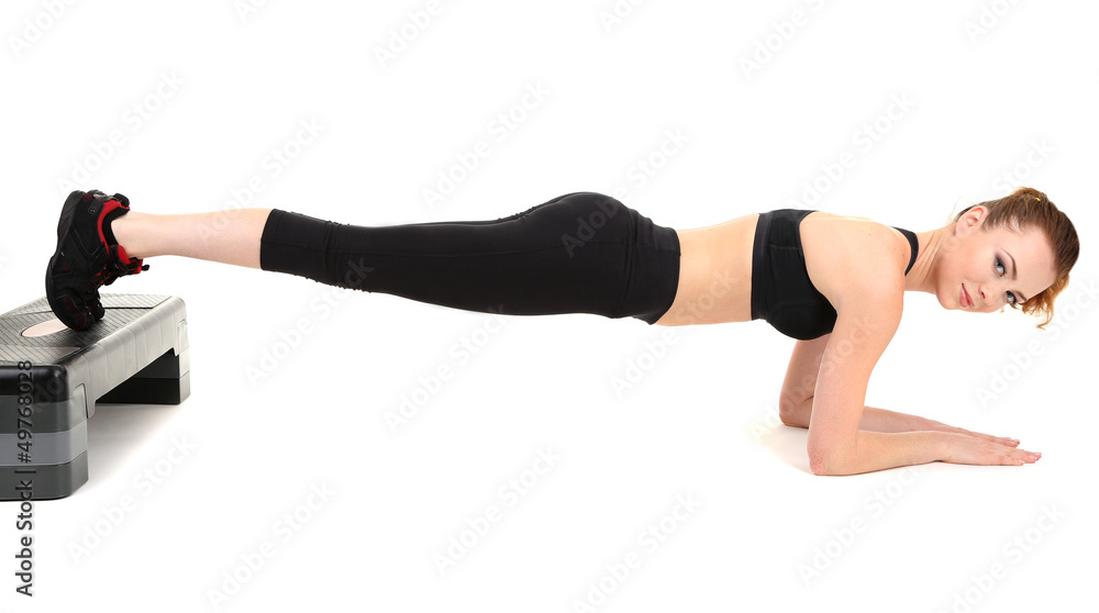 Young woman doing fitness exercises on stepper isolated on Young woman doing fitness exercises on stepper isolated on