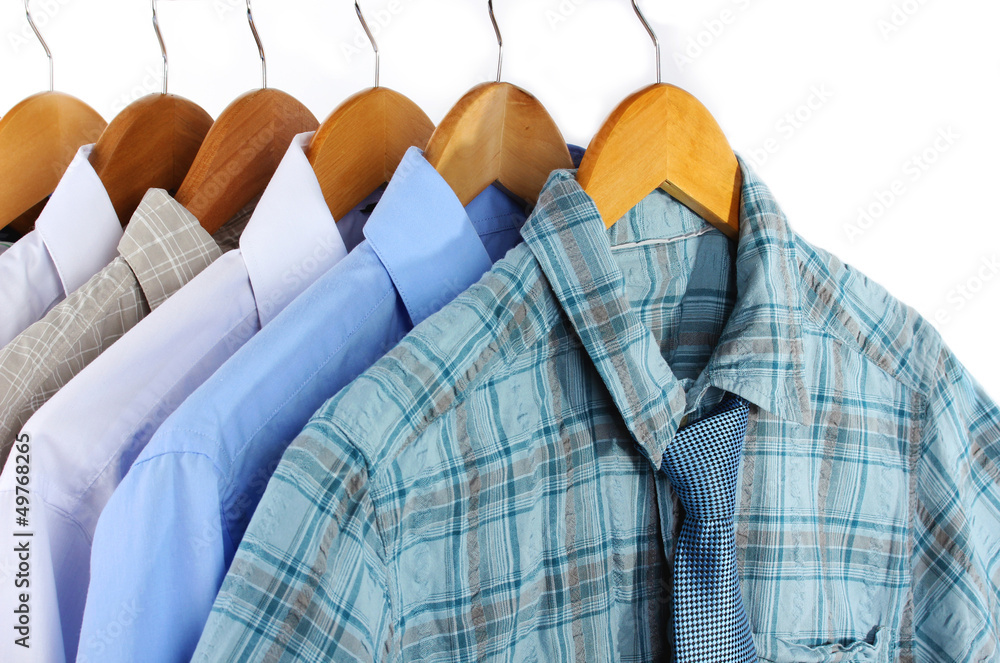 Shirts with ties on wooden hangers isolated on white Shirts with ties on wooden hangers isolated on white