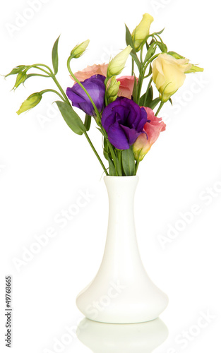 Bouquet of eustoma flowers in vase isolated on white © Africa Studio