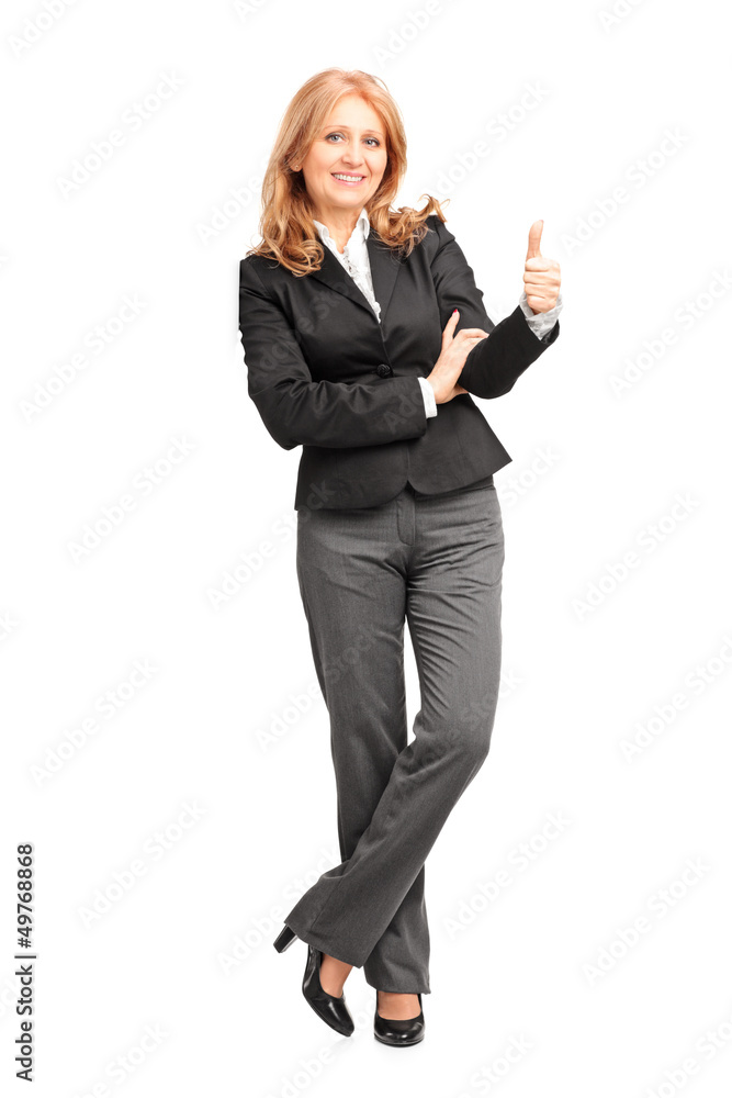 Full length portrait of a smiling businesswoman leaning on wall Full length portrait of a smiling businesswoman leaning on wall