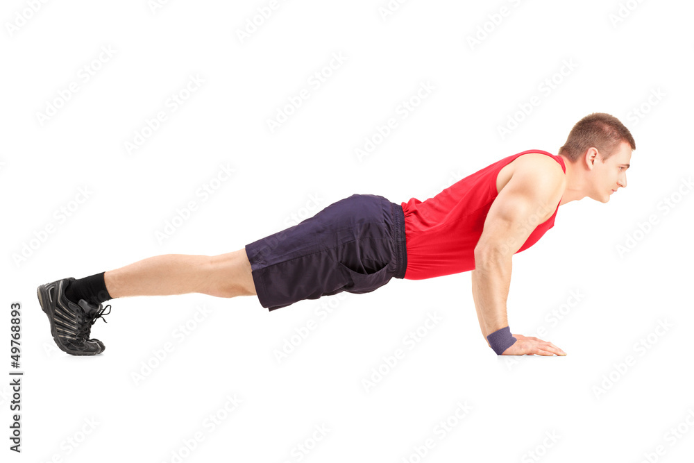 Male athlete in a sportswear doing push ups