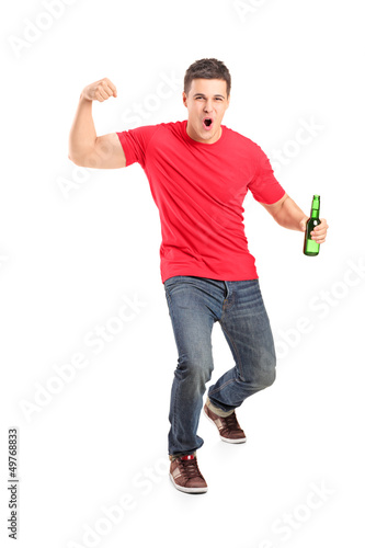 Full length portrait an euphoric fan holding a beer bottle and c