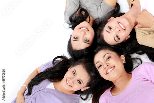 teenage girls lying on white floor