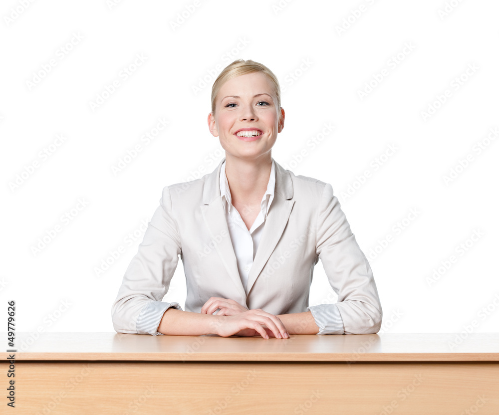 Young business woman sitting at a desk, isolated Young business woman sitting at a desk, isolated