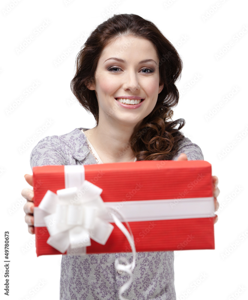 Young woman passes a p0resent wrapped in red paper Young woman passes a p0resent wrapped in red paper