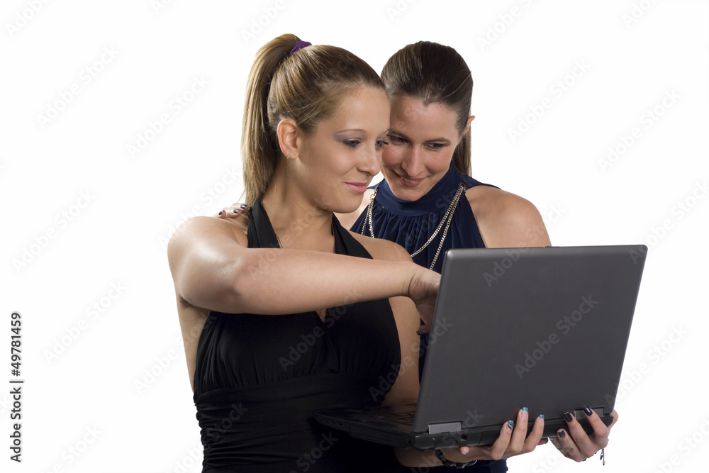 Two beautiful business women working on the laptop