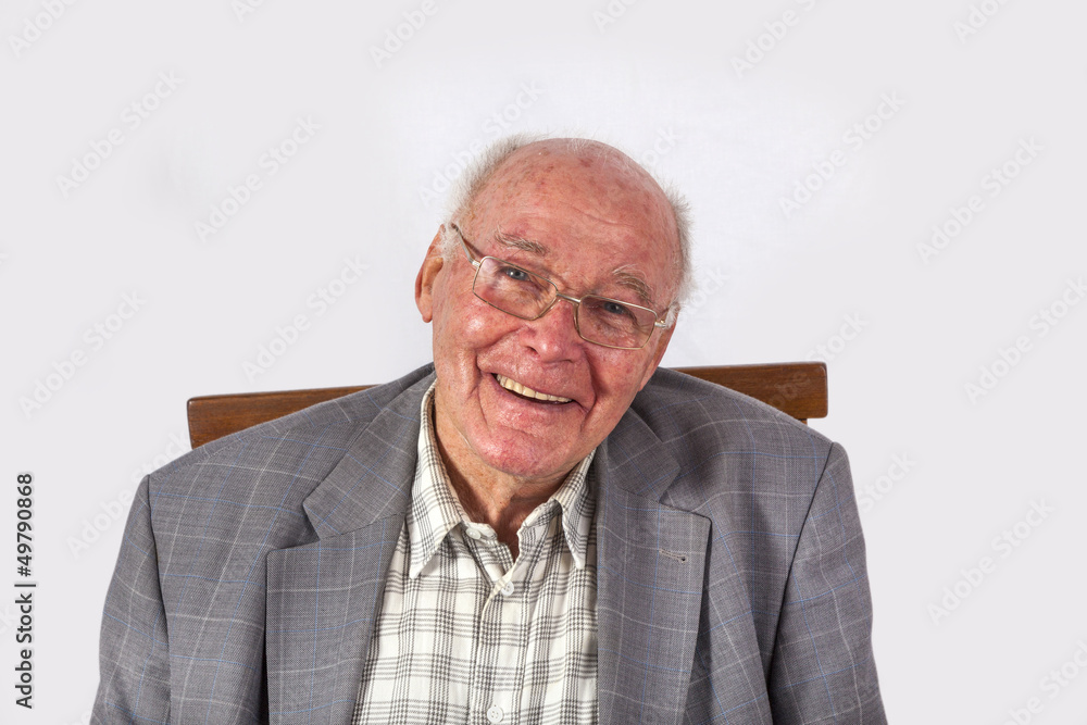 elderly smart confident man sitting in his armchair elderly smart confident man sitting in his armchair