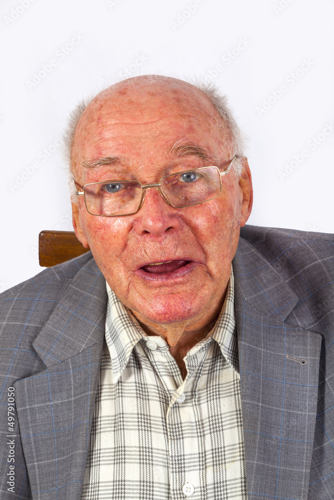 elderly smart confident man sitting in his armchair elderly smart confident man sitting in his armchair