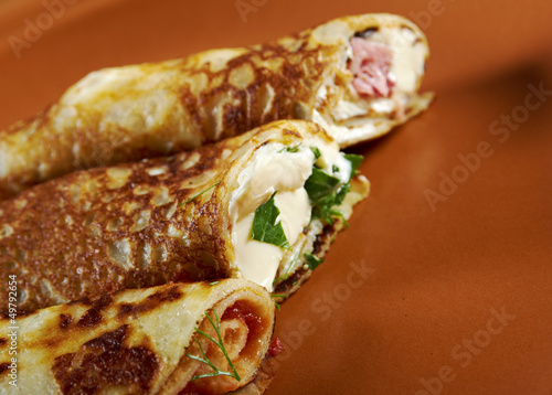 rolled pancakes stuffed ham and cheese. photo