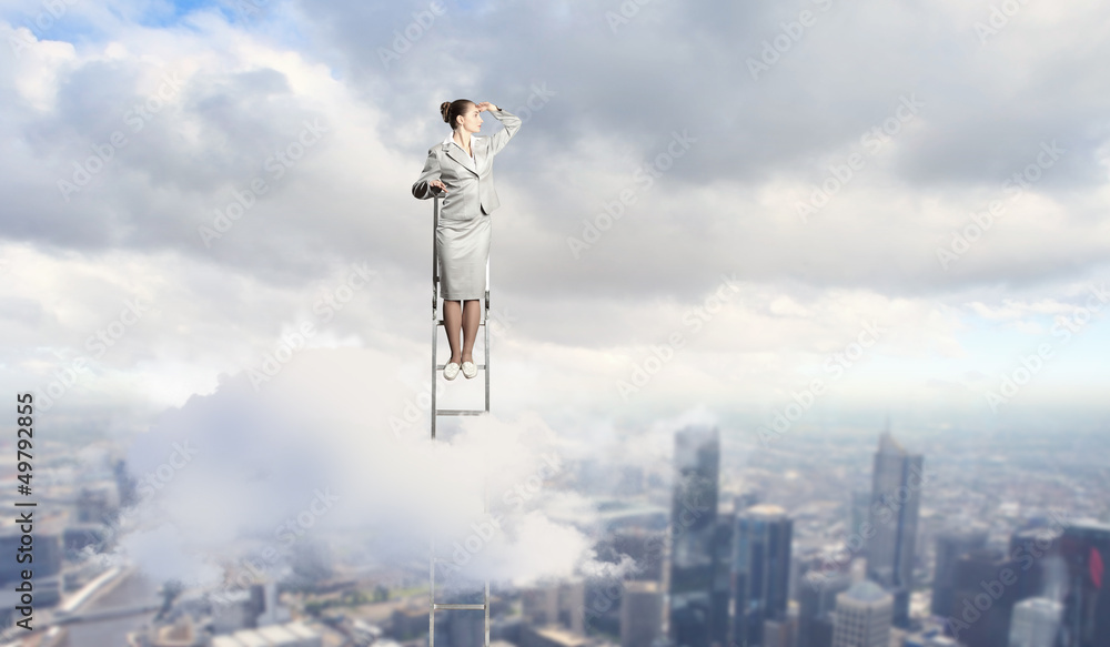 Businesswoman standing on ladder Businesswoman standing on ladder