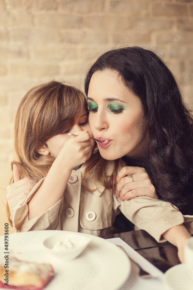 Mom and young daughter eating breakfast Mom and young daughter eating breakfast