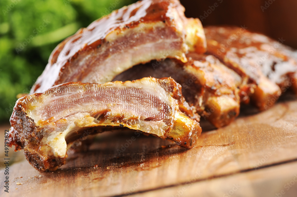close up of a sliced grilled barbecue ribs on a cutting board close up of a sliced grilled barbecue ribs on a cutting board