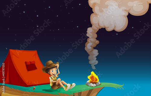 A boy with tent near the cliff