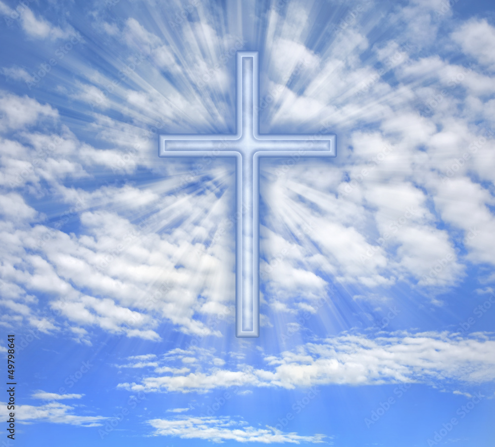 Christian cross with light beams over sky