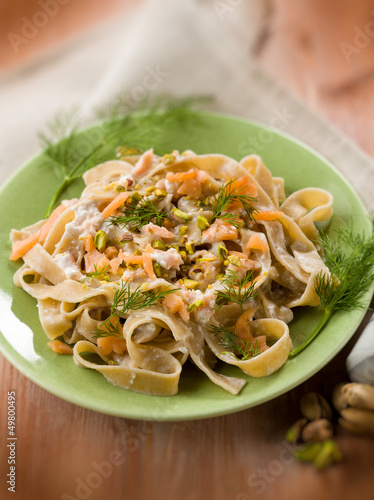 pasta with salmon pistachio and cream sauce, selective focus
