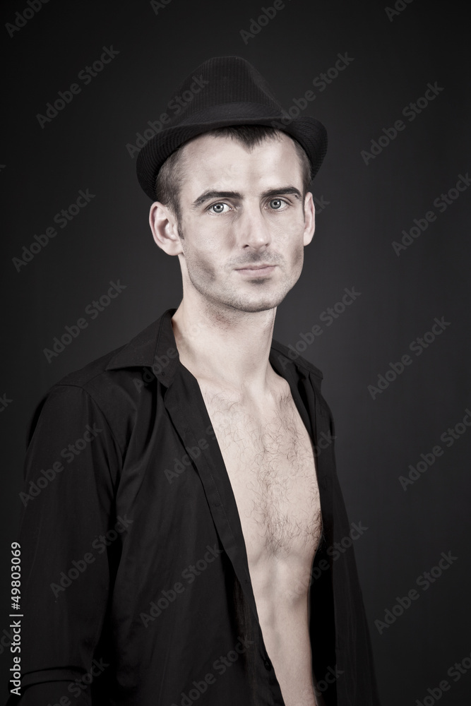 Pale man in a hat isolated on black Pale man in a hat isolated on black