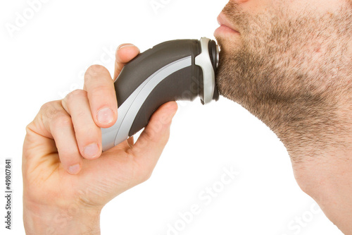 Young man shaving his beard off