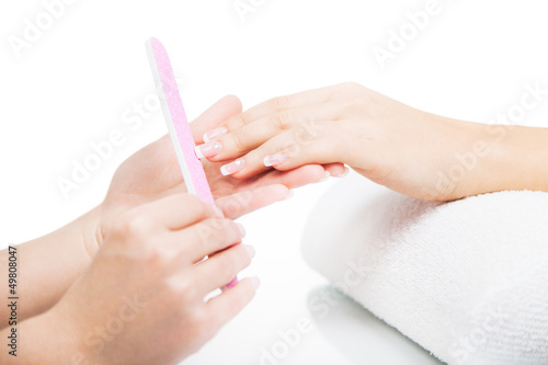 Beautiful female hands being manicured in a nail salon