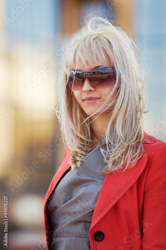 Young blond woman walking on a city street