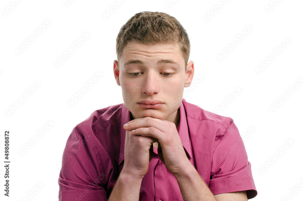 Thinking, not happy, disappointed.Young man looking down. Thinking, not happy, disappointed.Young man looking down.