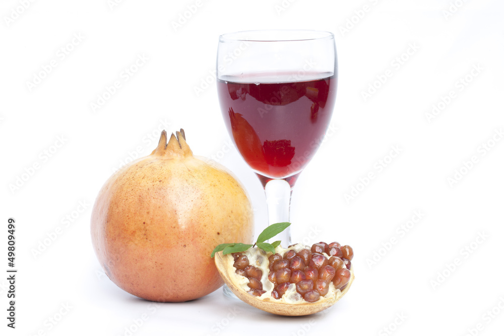 Pomegranate fruit and juice isolated on the white background Pomegranate fruit and juice isolated on the white background